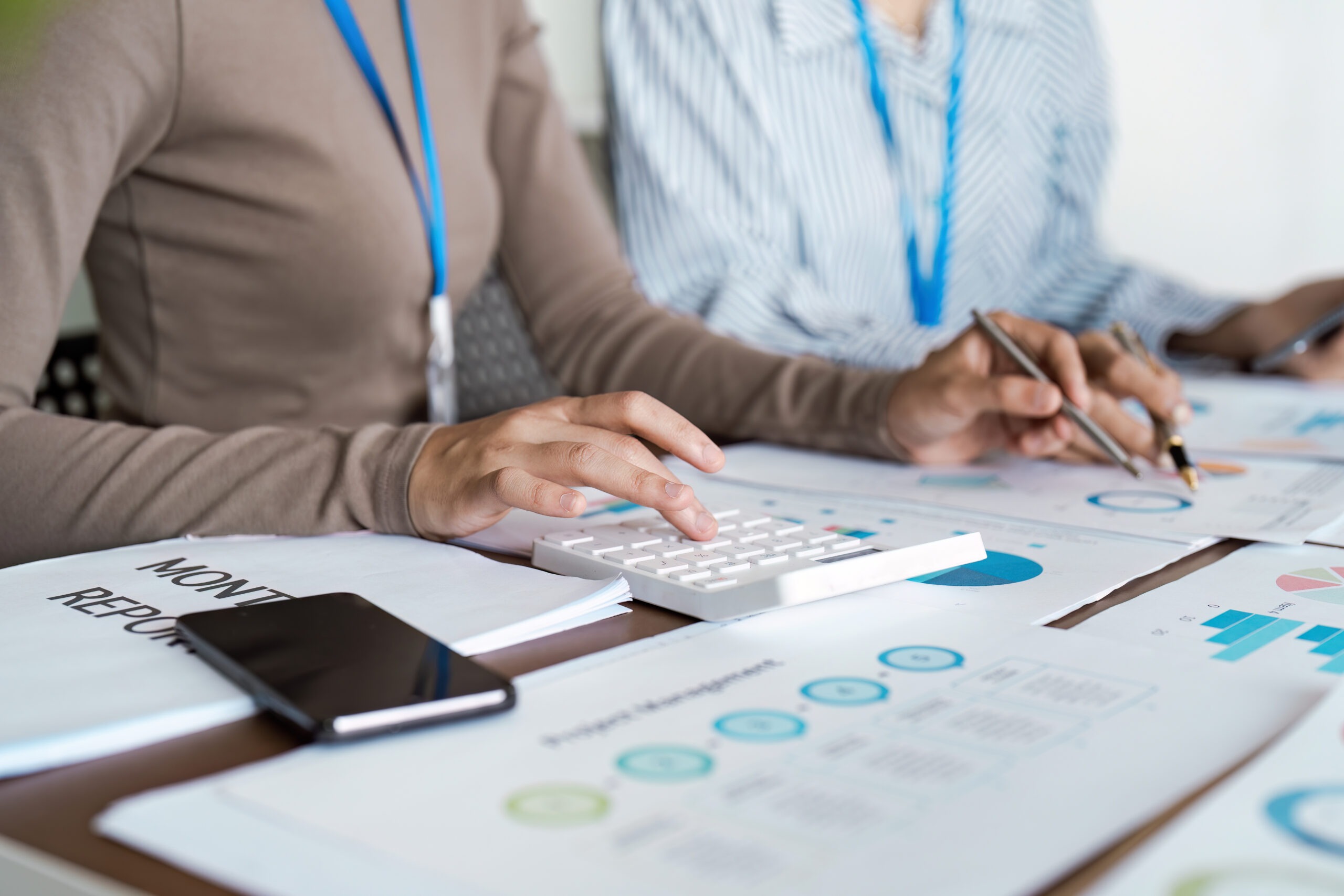 Businesspeople team collaboration analyzing monthly financial report with graph and chart. Analyzing result, Businesswoman accountant or financial expert analyze business