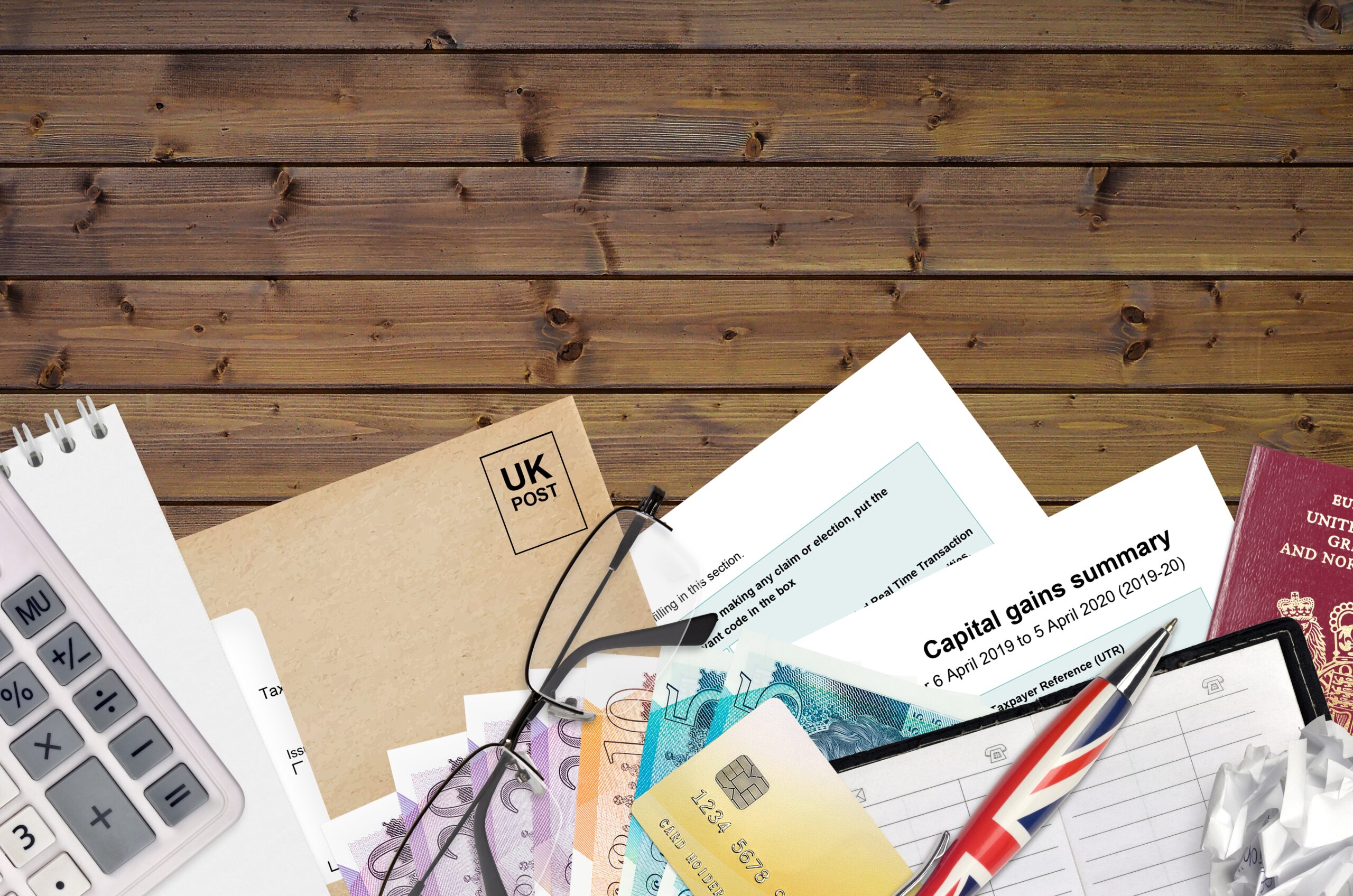 English Tax form sa107 Capital gains summary from HM revenue and customs lies on table with office items. HMRC paperwork and tax paying process in United Kingdom of Great Britain