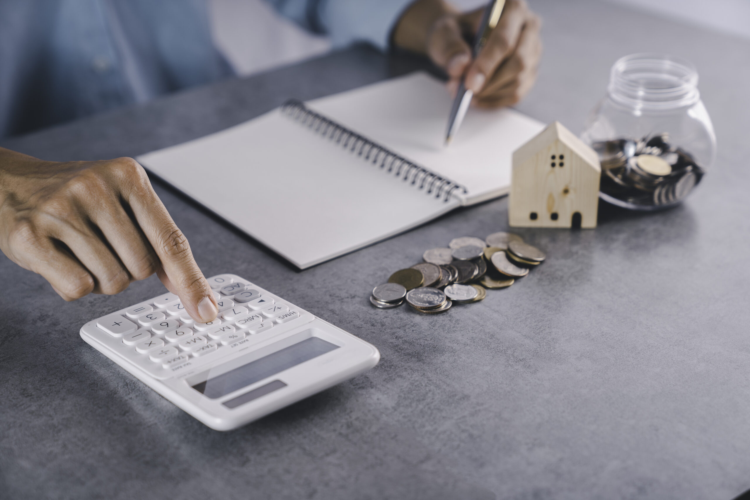 Real estate agents are calculating home loans. Sign contract on table real estate contract, home realtor and investment planning, businessman writing house rental form document, business idea.